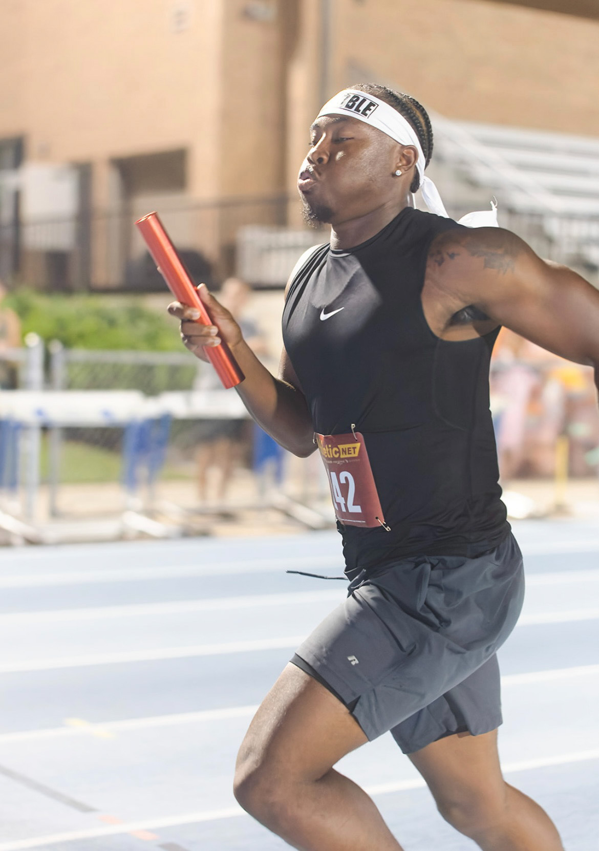 Panthers Elite athlete running with baton at The Victory Lap 2026.