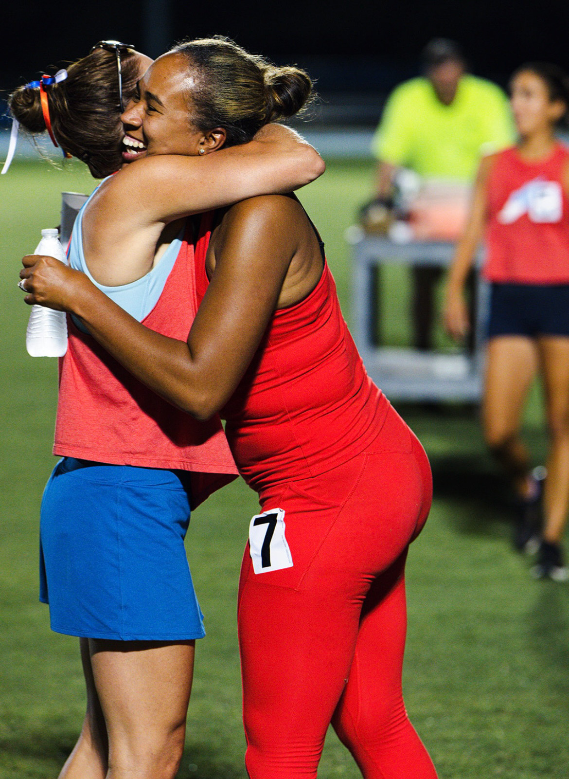 Two athletes hugging after a race at The Victory Lap 2026 event.
