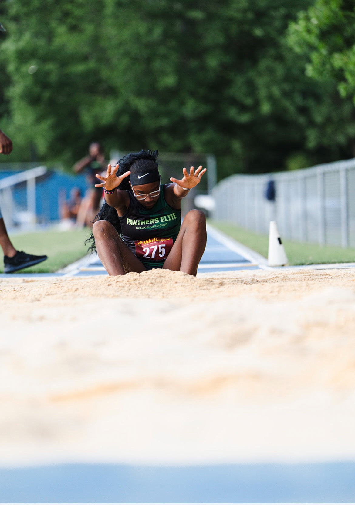 Panthers Elite athlete in mid-air during long jump at The Victory Lap 2026.
