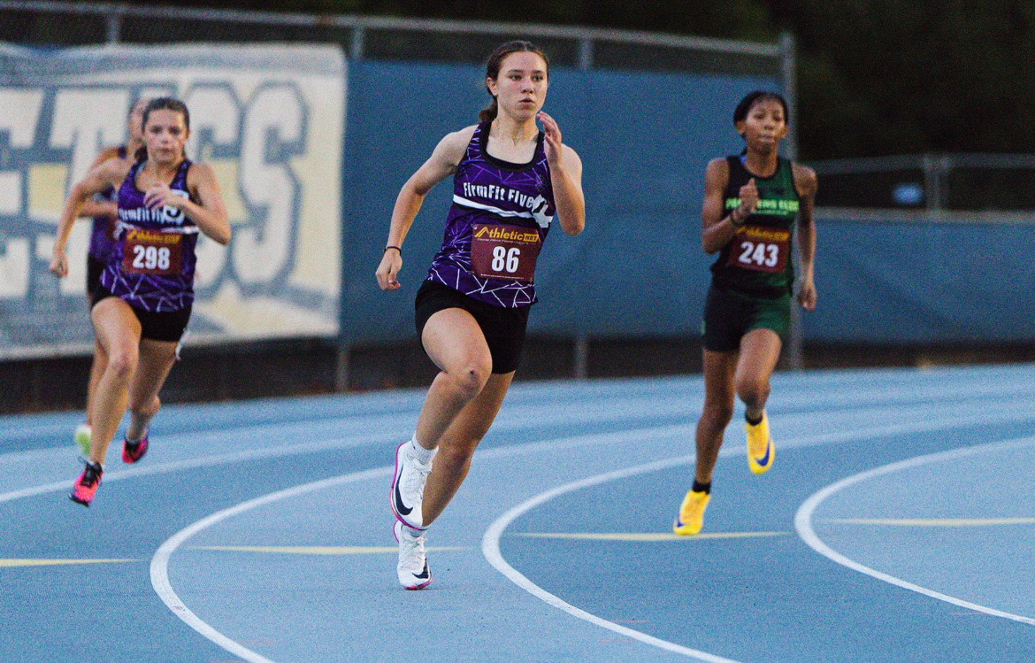 Young female sprinter competing in a track race at The Victory Lap 2026.