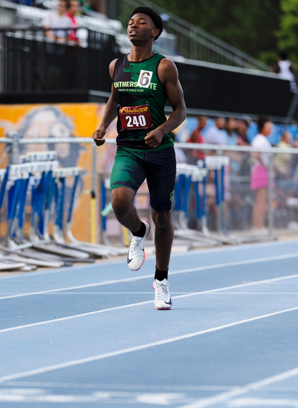Young athlete running on track at The Victory Lap 2026 event.
