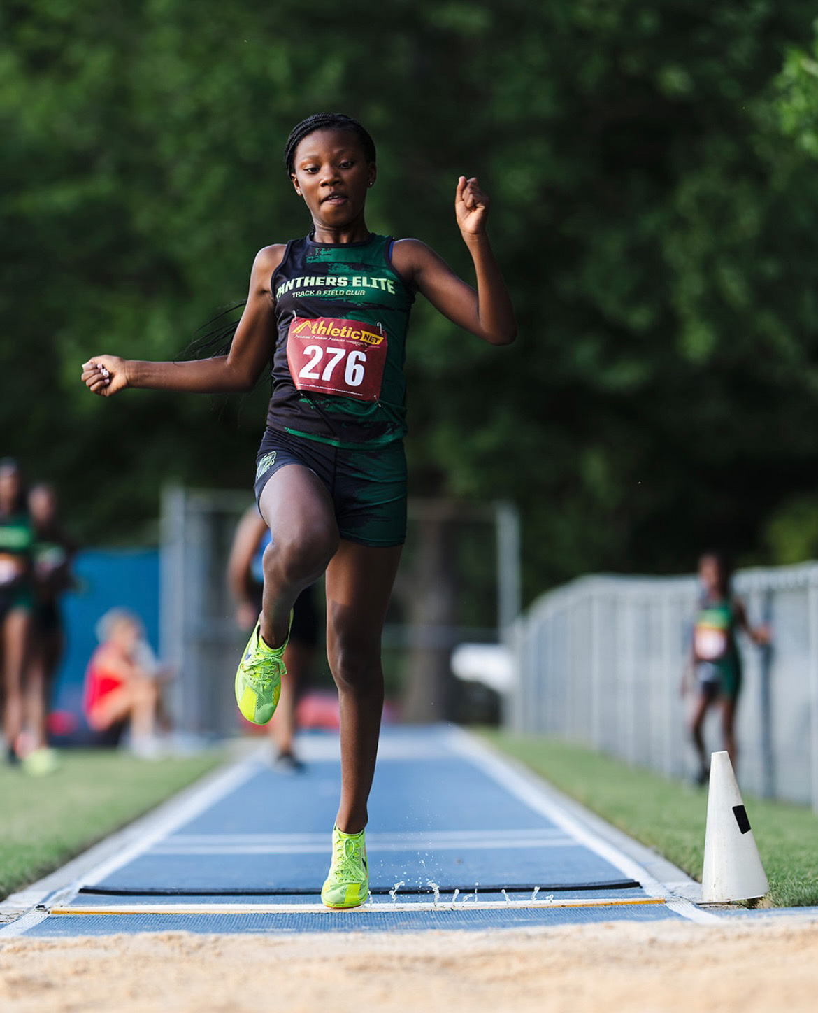 Young female athlete sprinting on track at The Victory Lap 2026 event.