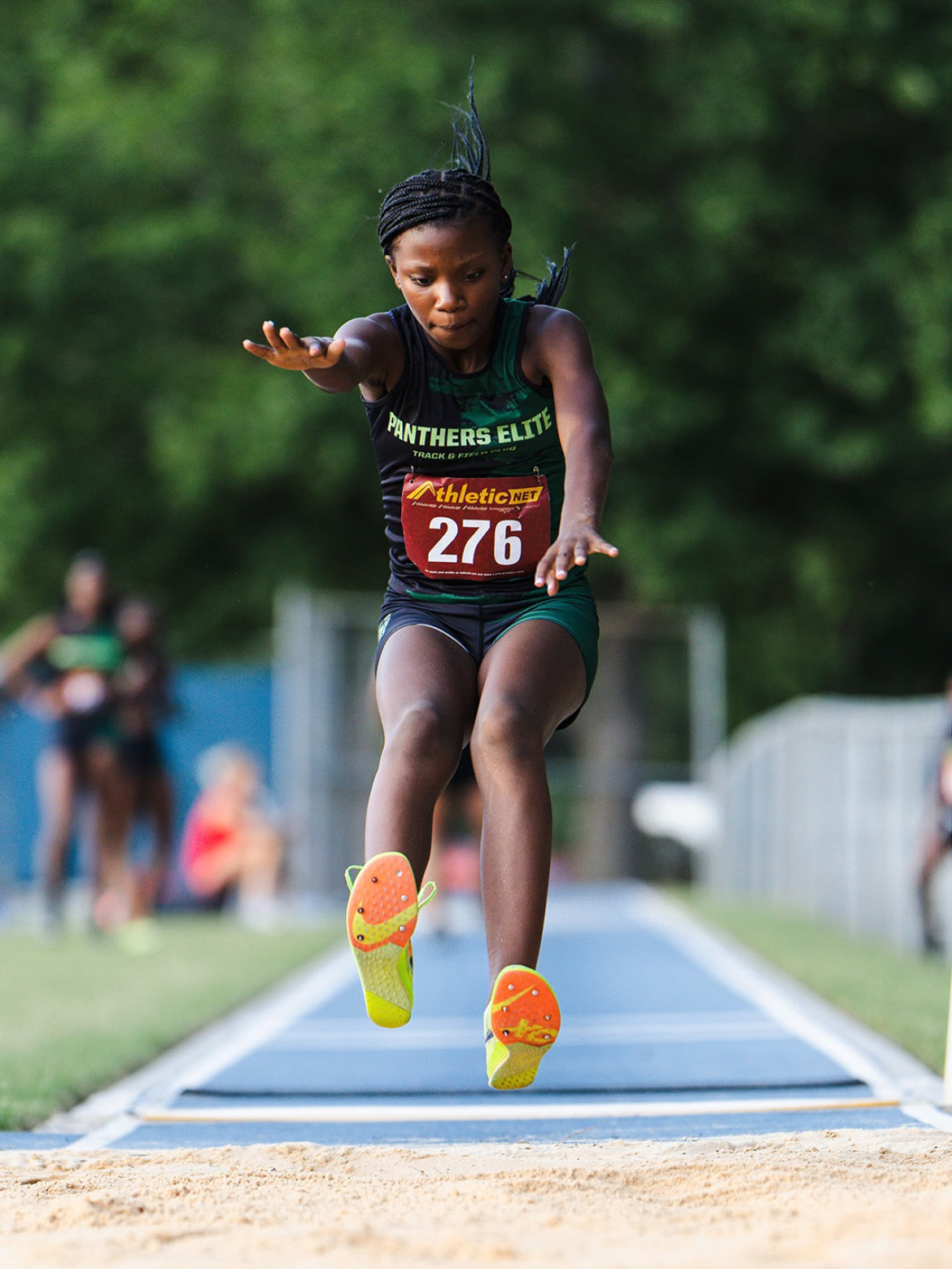 Young female athlete jumping during track and field event at The Victory Lap 2026.