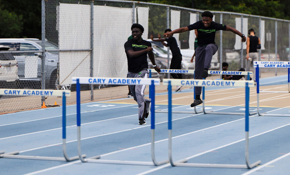 Young athletes competing in hurdles at Panthers Elite Track & Field event.