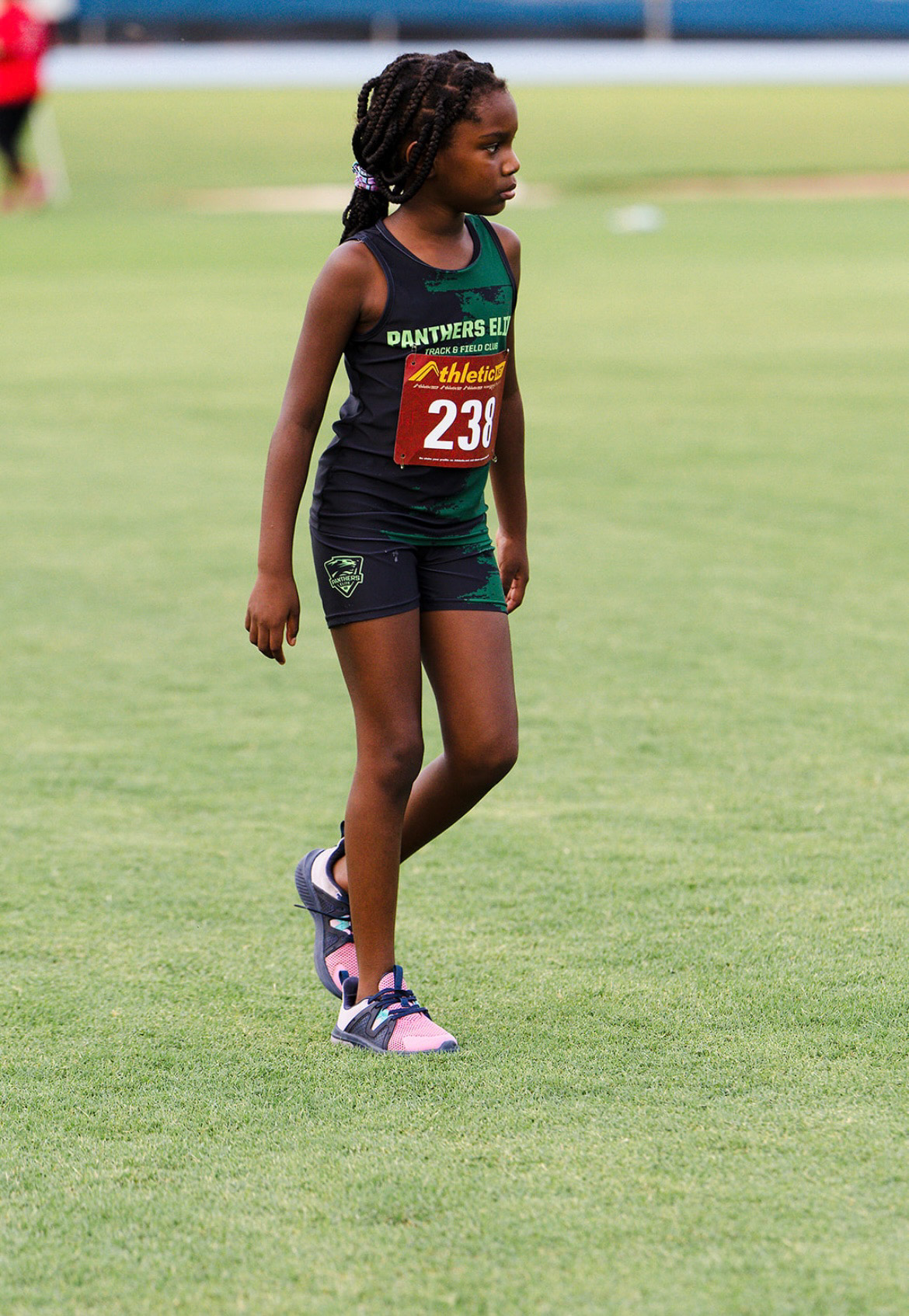 Young girl in Panthers Elite uniform running on track at Victory Lap 2026.