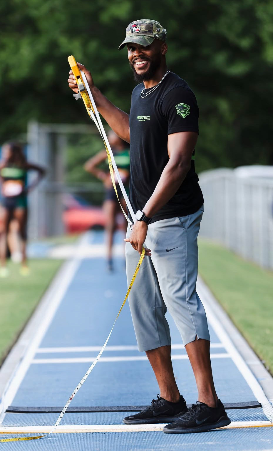 Panthers Elite coach smiling on track during The Victory Lap 2026 event.